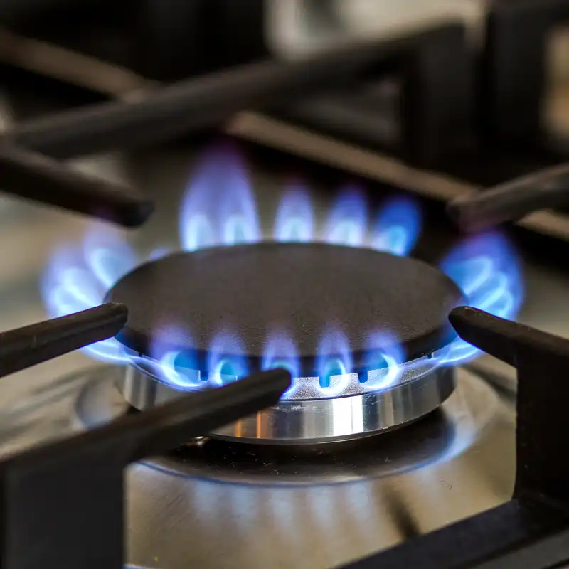 Blue gas flame burning on a kitchen cooktop, showing safe and efficient gas appliance operation