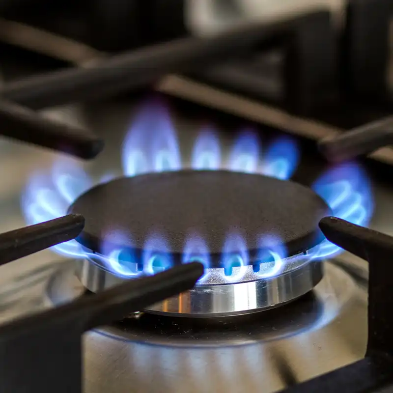 Even blue flame on gas cooktop Blue flame burning evenly on a modern gas cooktop